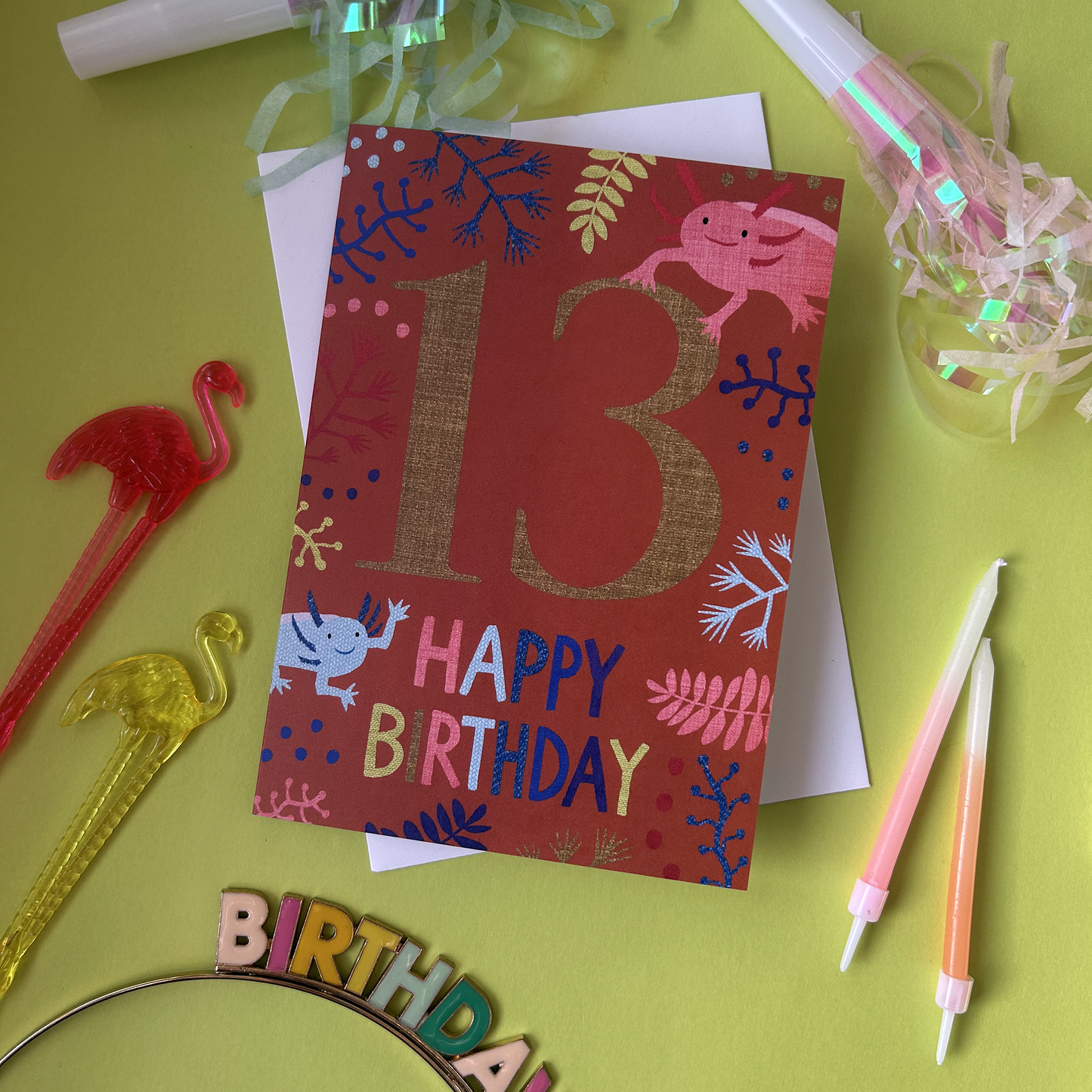 Birthday card with number 13 and 'Happy Birthday' text on a green background with party supplies.