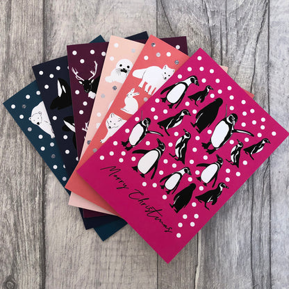 Image shows 6 brightly coloured Christmas cards featuring illustrations of different Arctic animals.