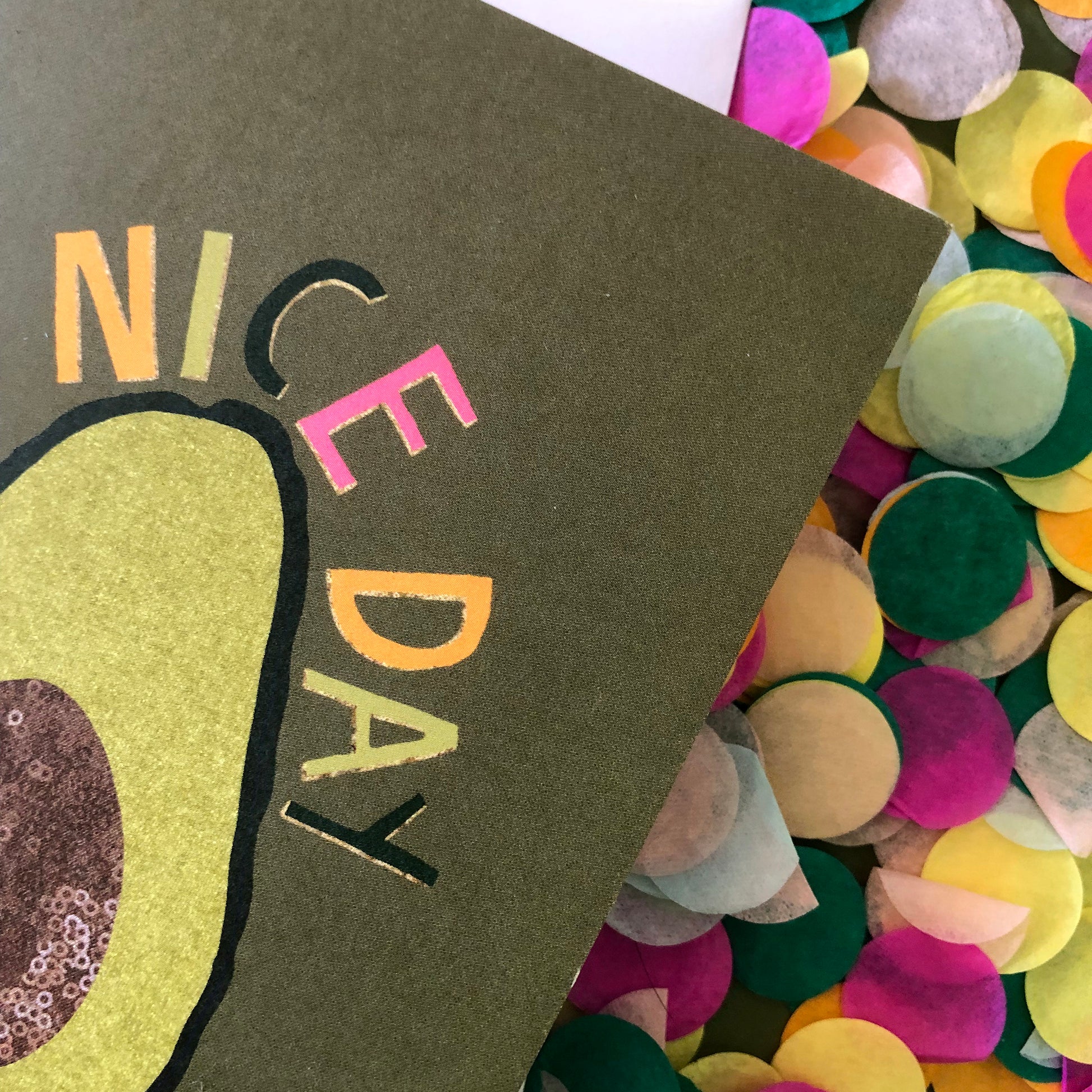 Image shows a green "everyday" greetings card that says 'avo nice day' and features an illustration of an avocado