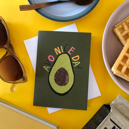 Image shows a green "everyday" greetings card that says 'avo nice day' and features an illustration of an avocado