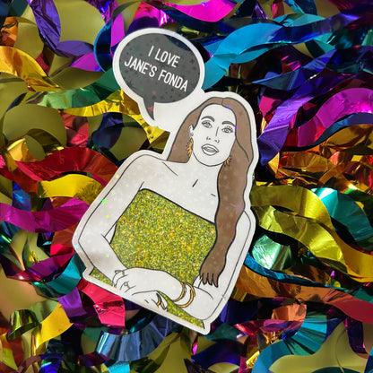 Illustration of a person with a green dress on a colorful, confetti-like background with 'I Love Jane's Fonda' text.