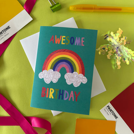 Colourful birthday card with rainbow and 'Awesome Birthday' text on a colourful background.