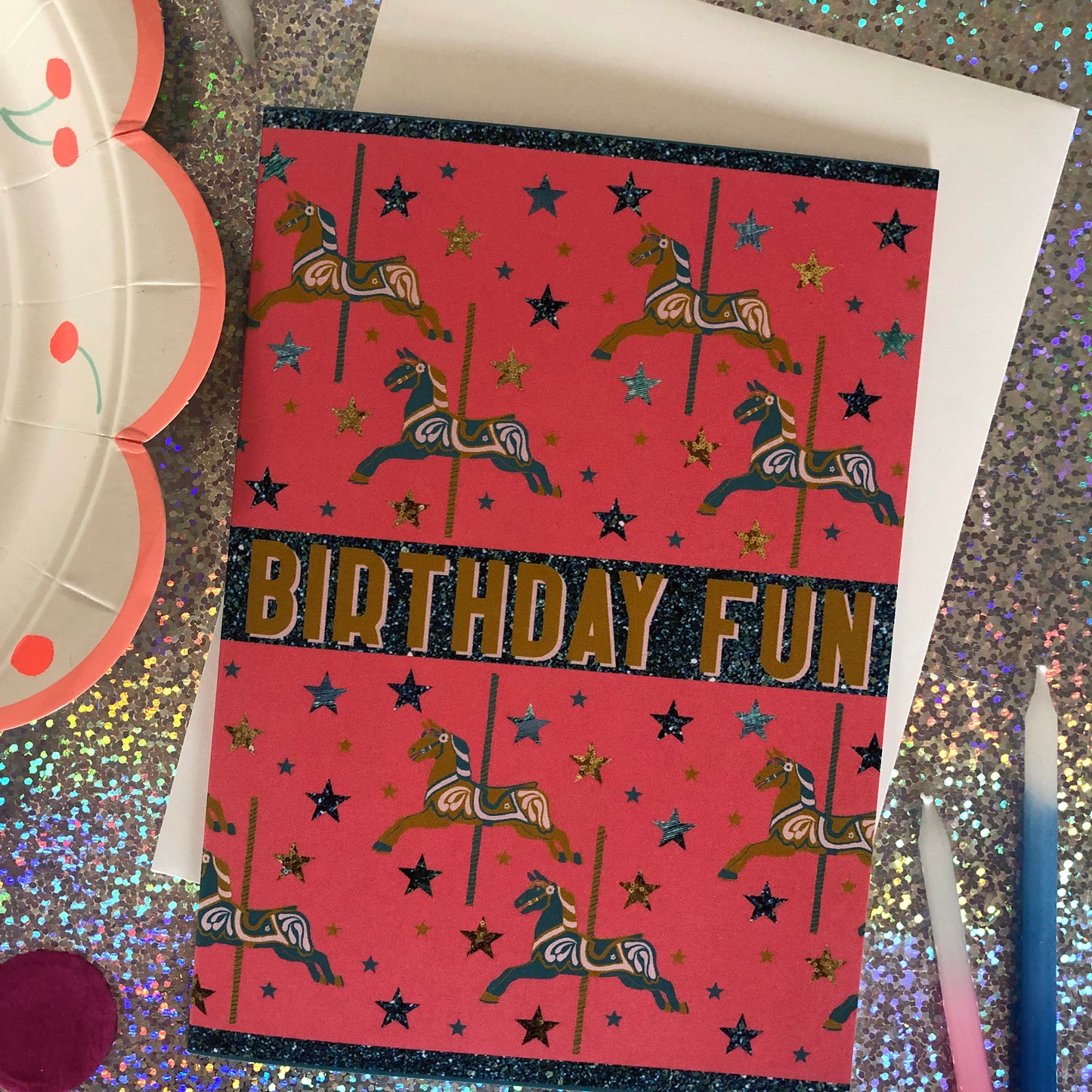 Bright and fun birthday card featuring a carousel horse design on a background of confetti