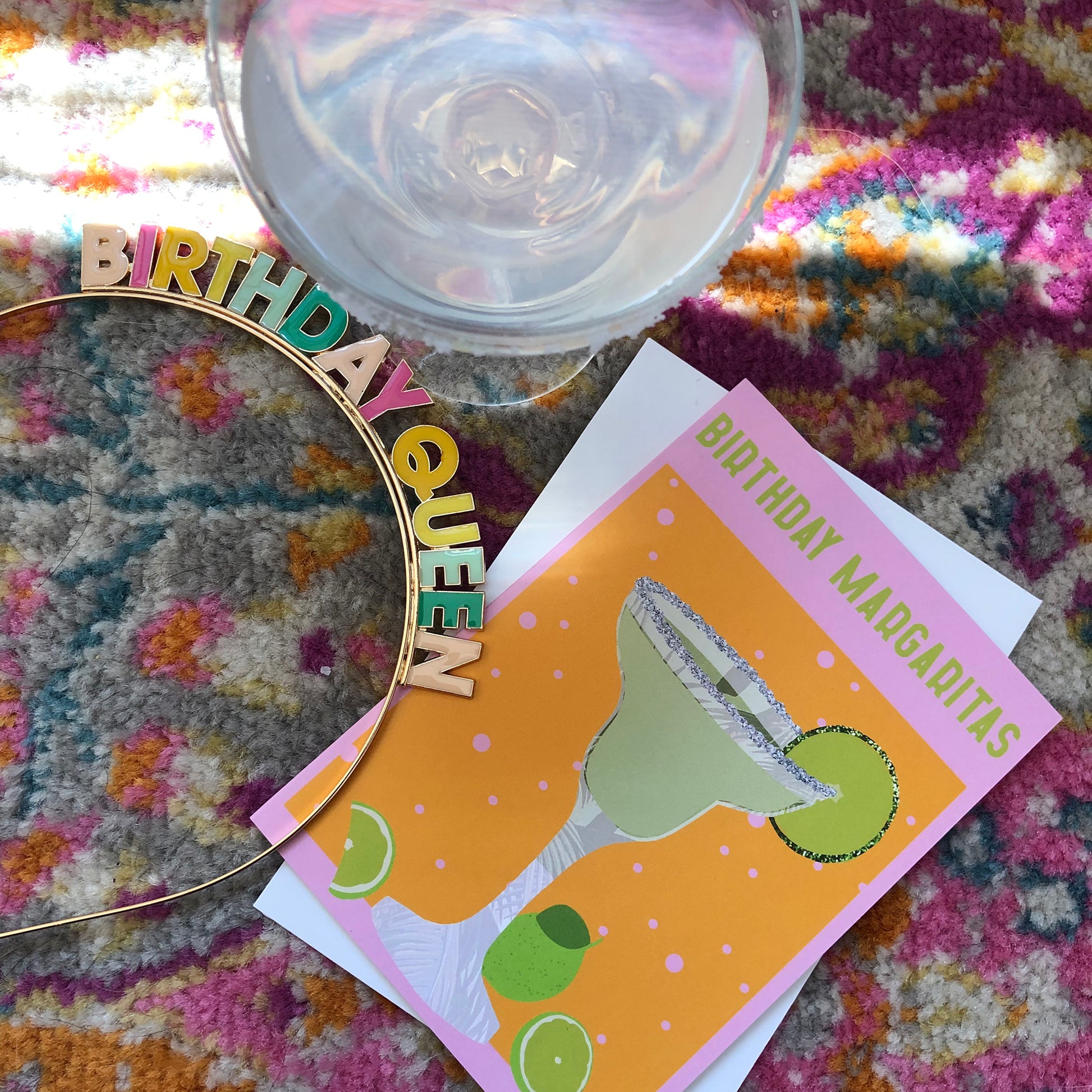 Image shows a yellow and pink coloured  birthday card with the greeting 'Birthday Margaritas' and a lime green cocktail with limes and a glitter salt rim.