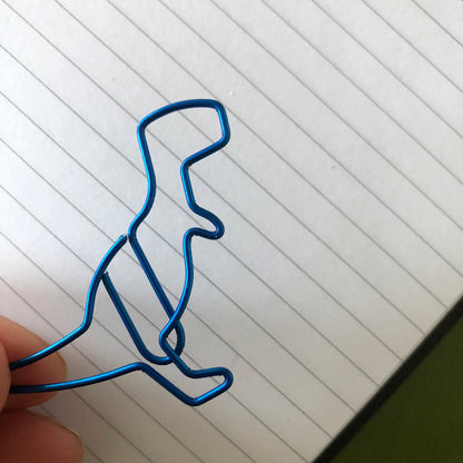 Image shows a single metallic blue dinosaur shaped paperclip.