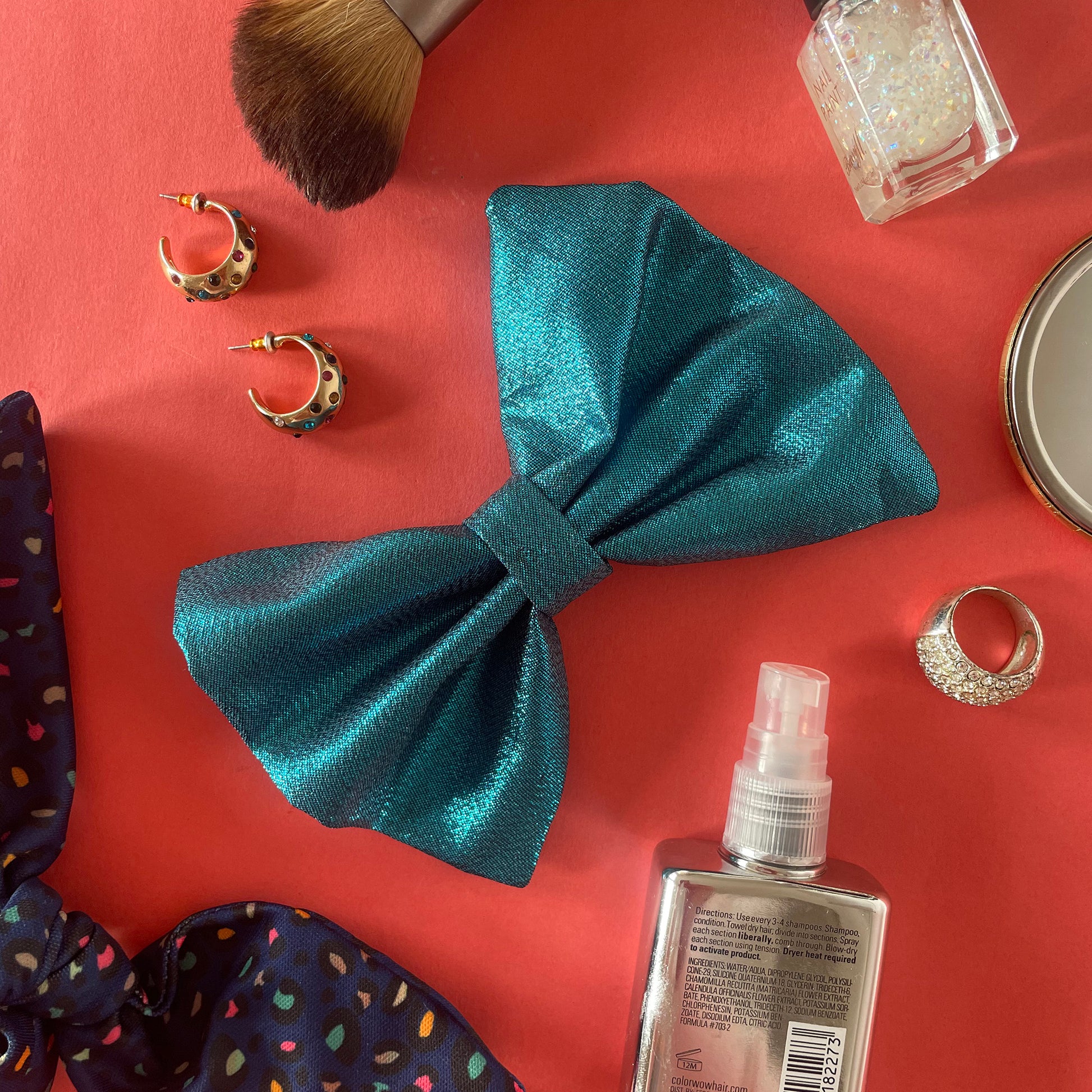 Image shows a blue metallic hair bow made from high quality lamé fabric.