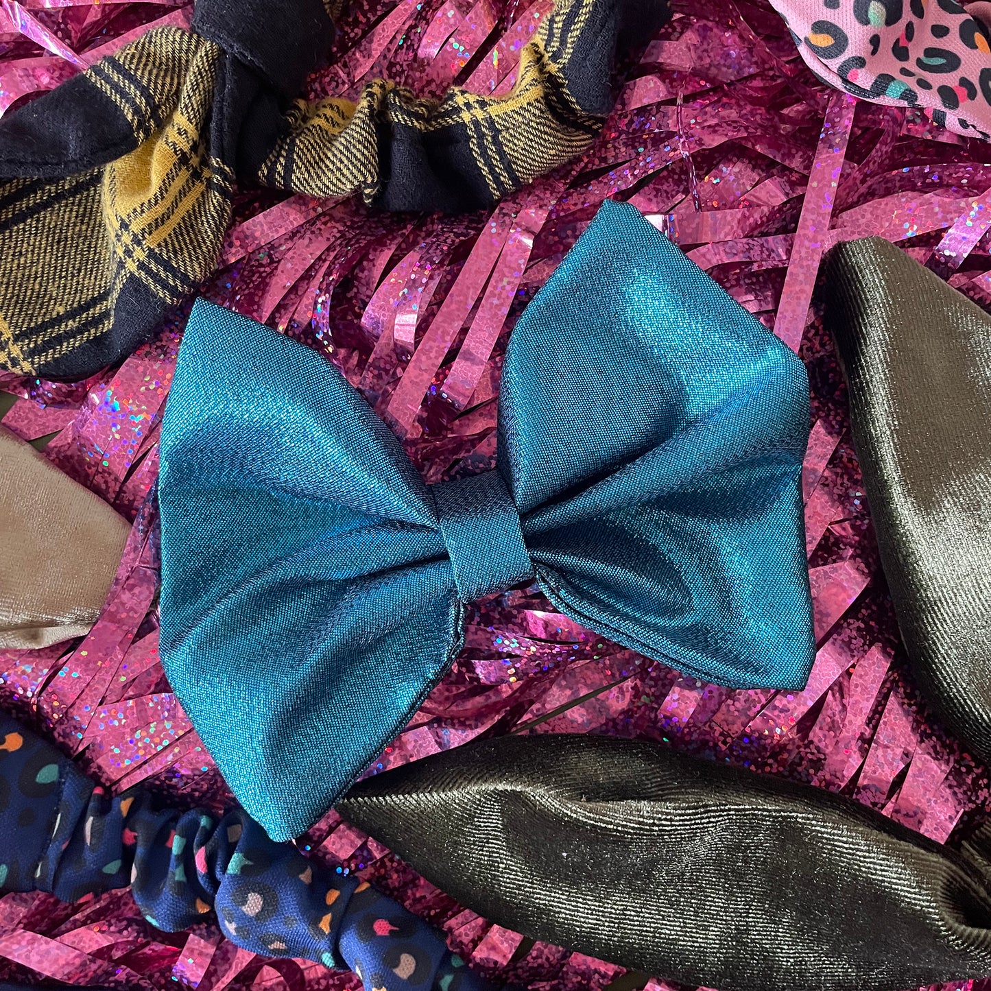 Image shows a blue metallic hair bow made from high quality lamé fabric.