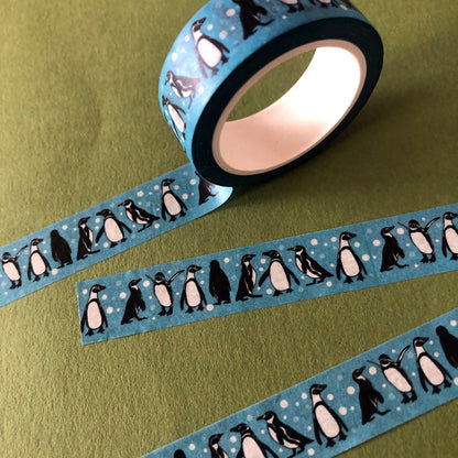 Image shows a blue washi tape with a fun penguin and snowball print