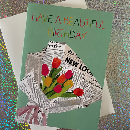 Image of a pastel green card that reads Have a Beautiful Birthday and features a unique, collaged illustration of a bouquet of tulips in newspaper.