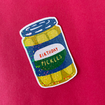 Sticker of a jar labeled 'Birthday Pickles' on a red background