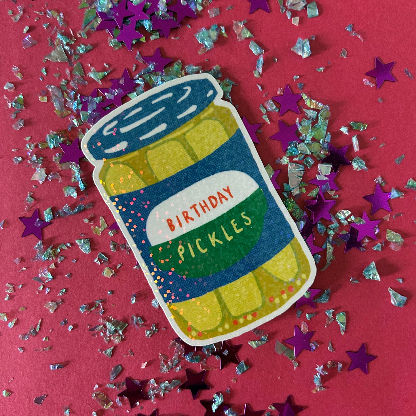 Sticker of a jar labeled 'Birthday Pickles' on a red background with confetti.