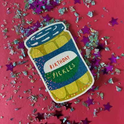 Sticker of a jar labeled 'Birthday Pickles' on a red background with confetti.