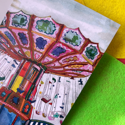 Close up of a greeting card with a colourful carousel design.
