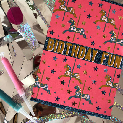 Bright and fun birthday card featuring a carousel horse design on a background of confetti