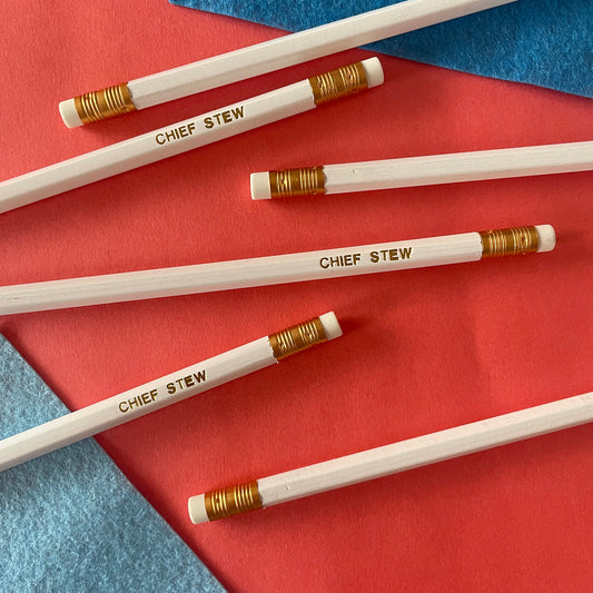 Image of a white pencil with 'chief stew' embossed on it in gold lettering