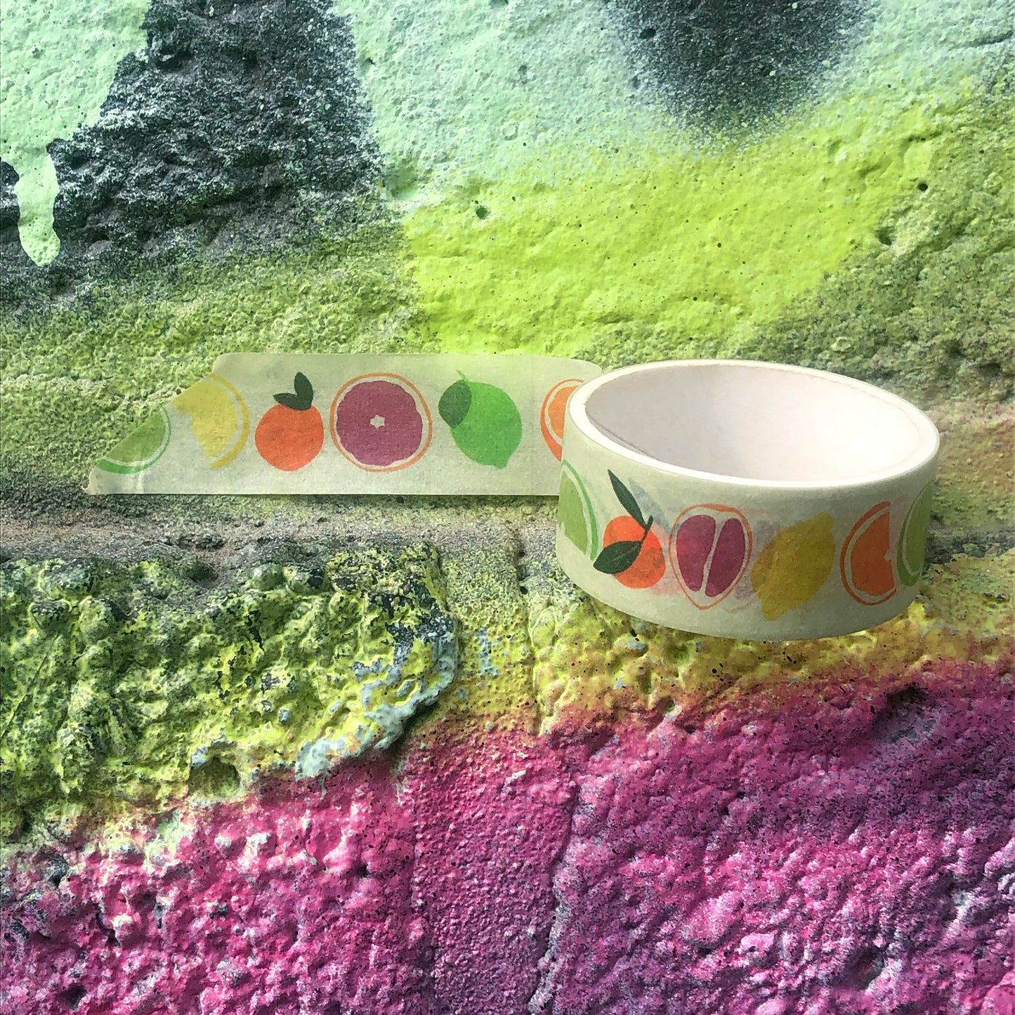 Image shows a pale green washi tape with a colourful citrus fruit print