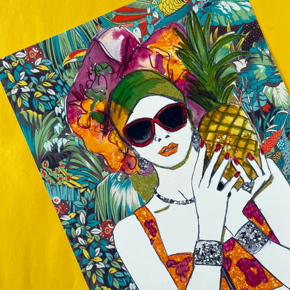 Image shows a framed illustration of a woman holding a pineapple with a colourful head wrap and a bright, tropical, collage background