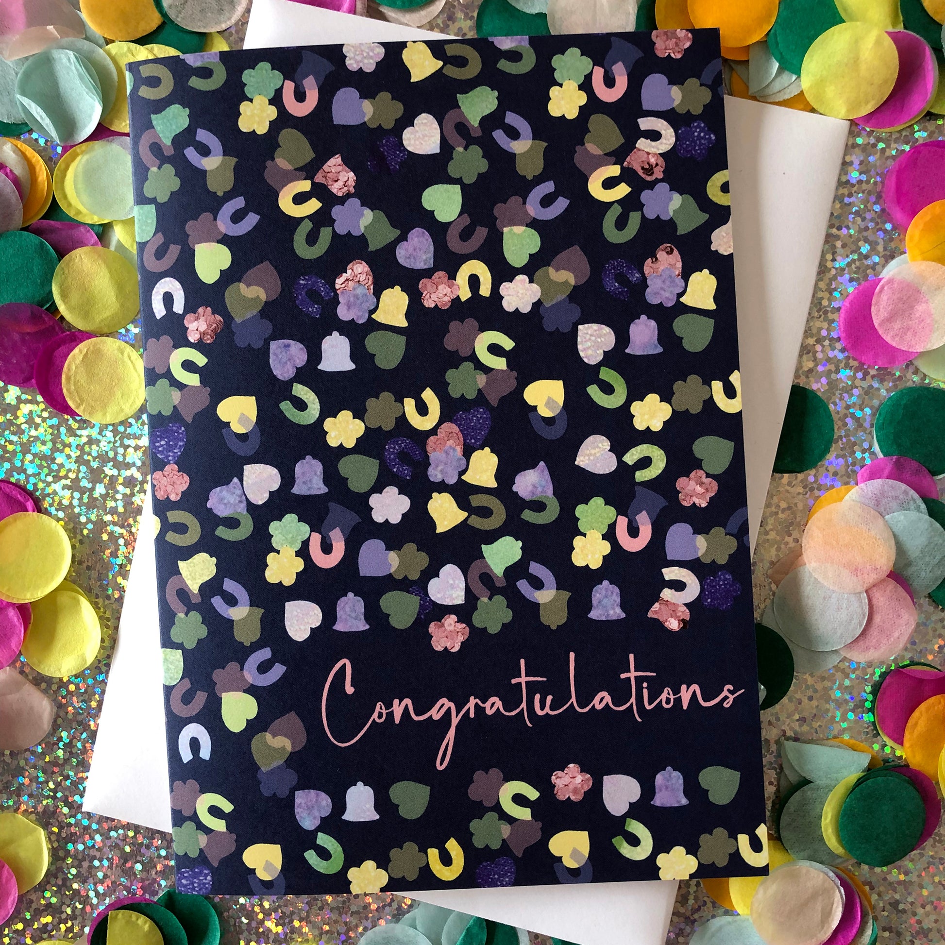 Image shows a navy blue card with a confetti print pattern and 'Congratulations' in pink writing 