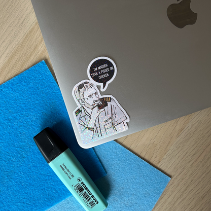 Laptop with a Captain Lee holographic vinyl sticker and a highlighter on a desk.