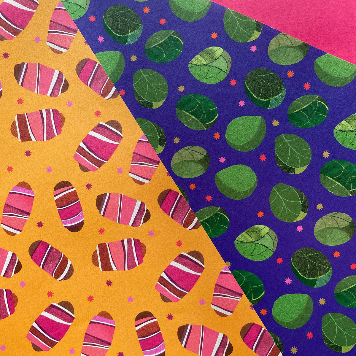 Two wrapping paper sheets with different patterns: one with colourful pigs in blankets on yellow and the other with green sprout designs on purple.