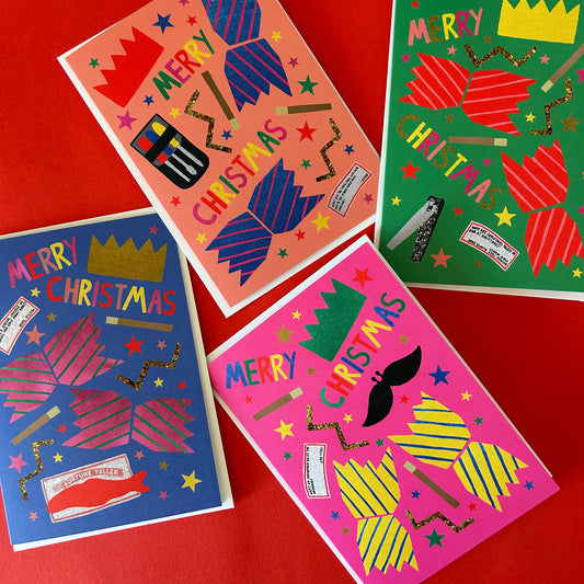 Four colourful Christmas card designs arranged on a red background, each featuring festive text like 'Merry Christmas' and abstract holiday graphics in bright pink, blue, green, yellow, and red.