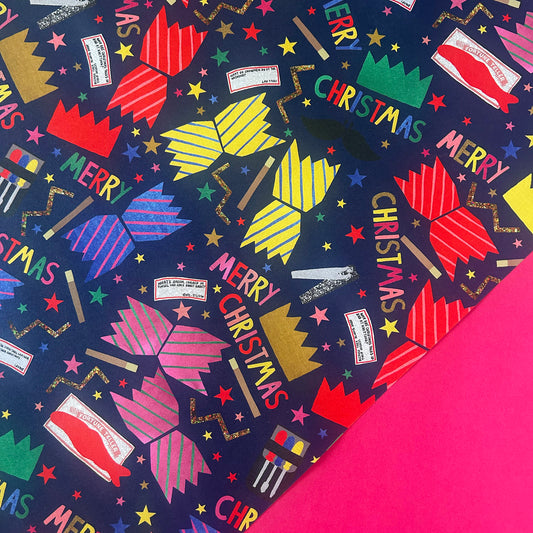 A close-up of a Christmas-themed patterned wrapping paper with bright, colourful Christmas Cracker design.