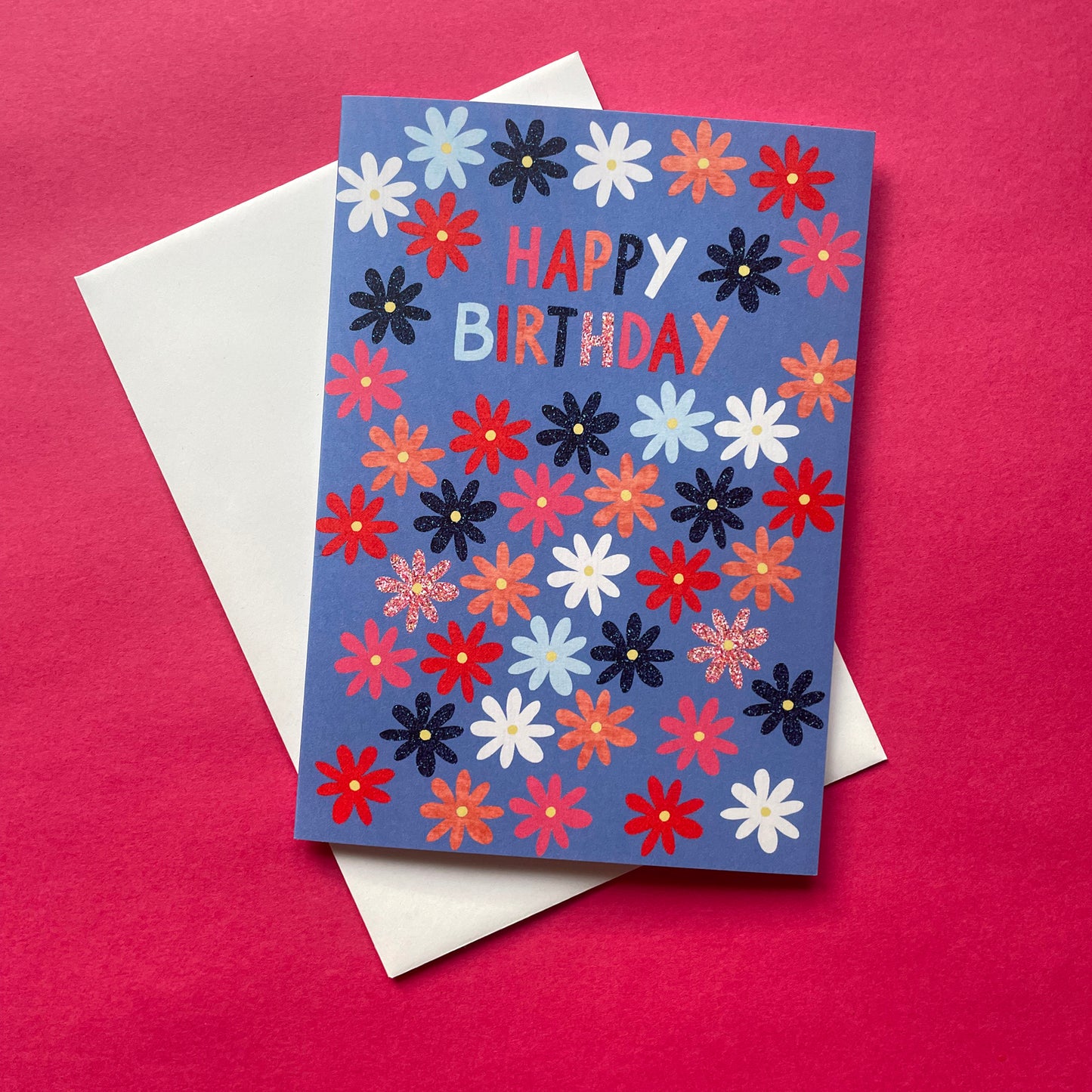 Colorful floral birthday card with 'Happy Birthday' text on a pink background