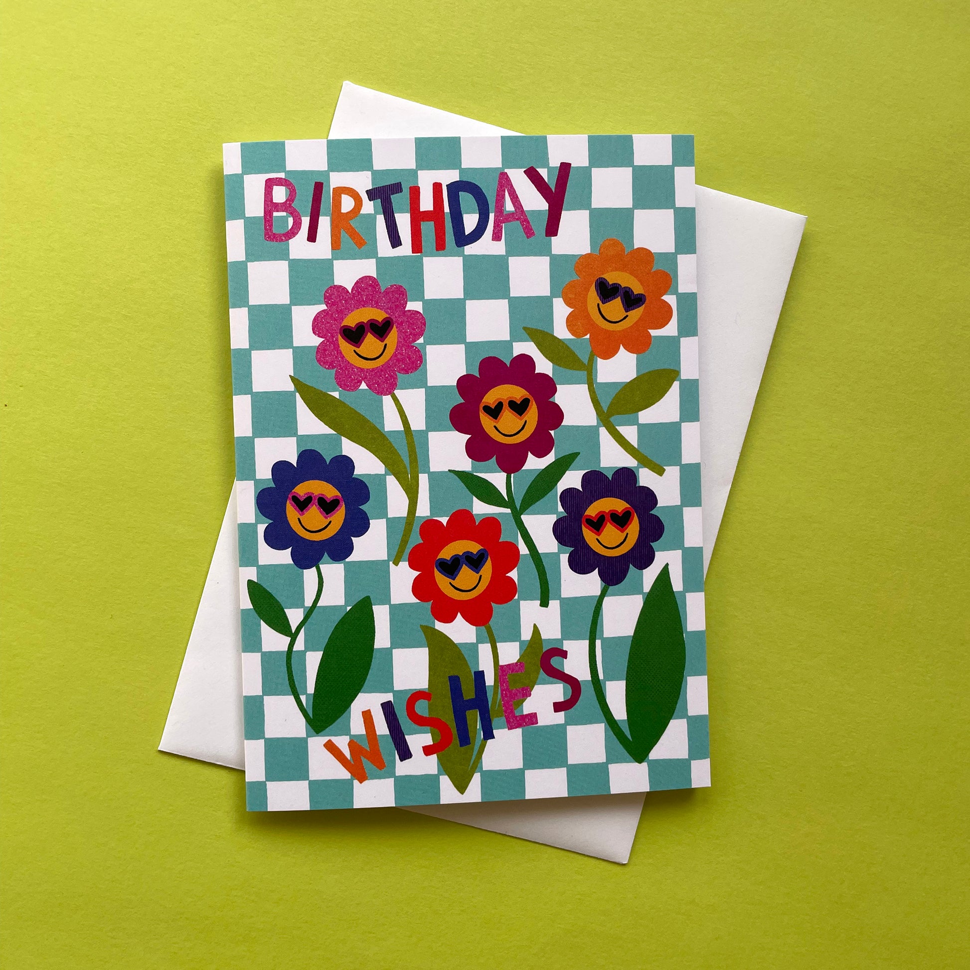 Birthday card with floral design and 'Birthday Wishes' text on a checkered background