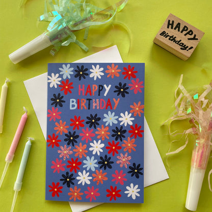 Colorful birthday card with flowers on a green background