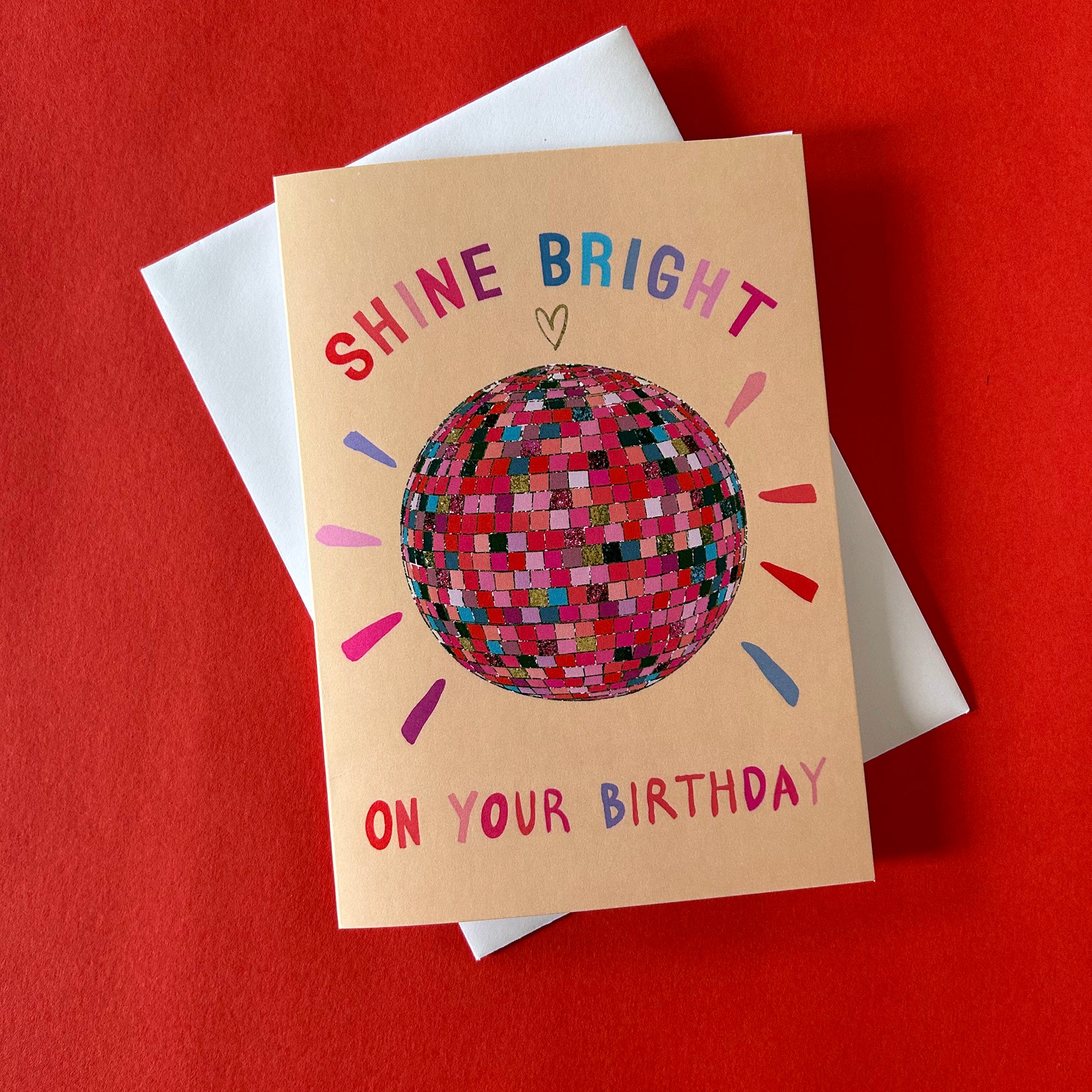 Birthday card with disco ball illustration and text on a red background