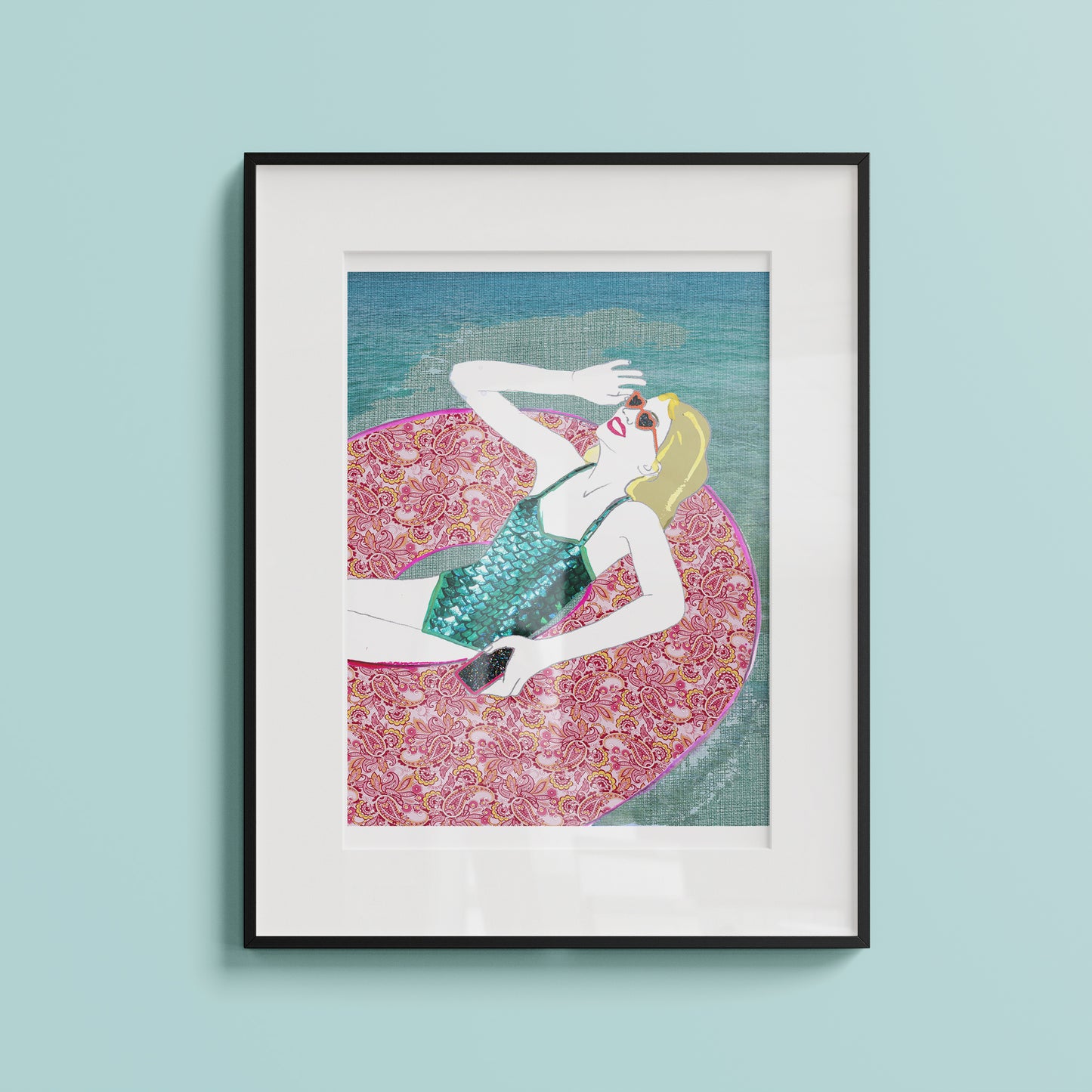 Framed artwork on a blue wall, illustration of a woman relaxing in a pool ring in the summer