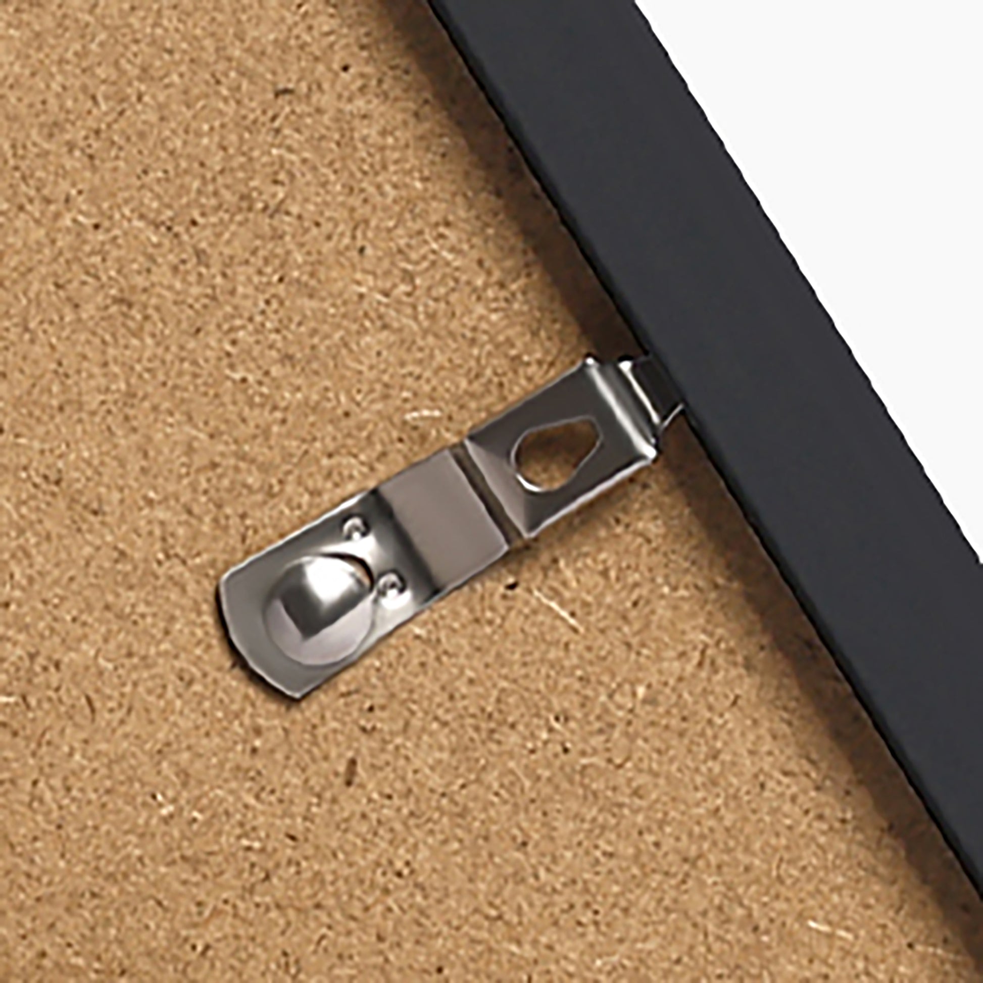 Metal picture frame latch on the back of a framed art print
