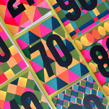 A close-up of a colourful geometric patterned greetings card.