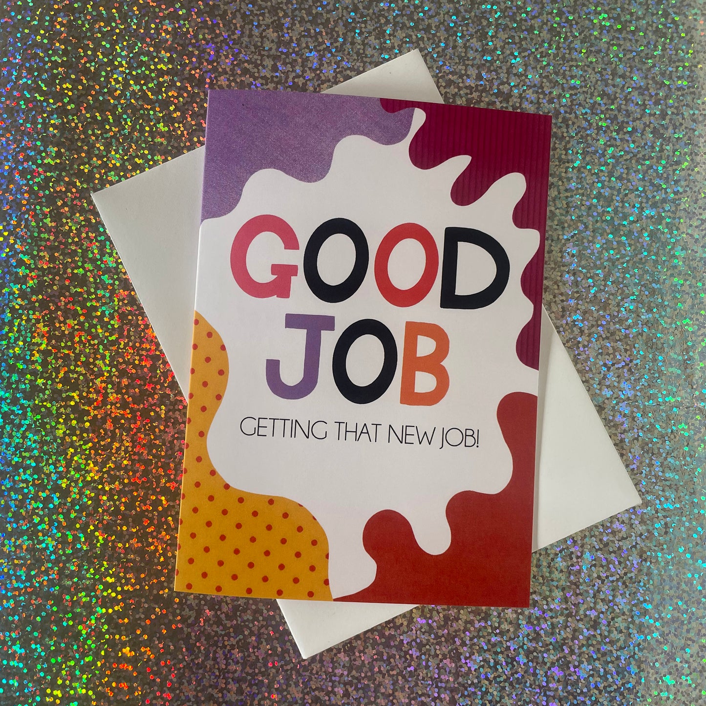 Image shows a bright greetings card with colourful, abstract shapes around the edge and the wording "Good Job getting that new job!"