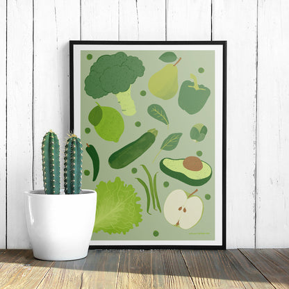 Image of a framed art print of green fruit and vegetables on a green background.