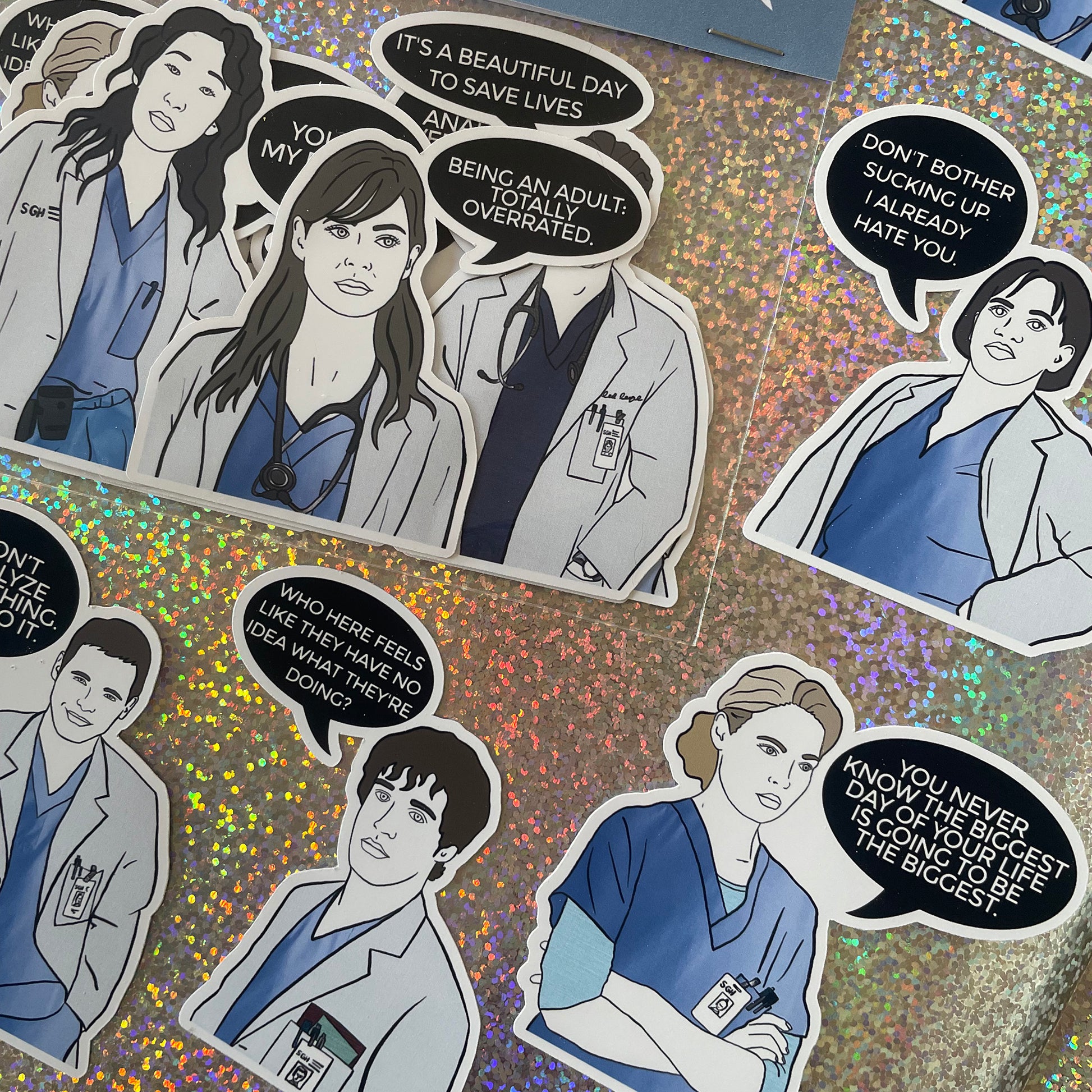 Image shows a set of hand drawn stickers inspired by the cast of Grey's Anatomy.