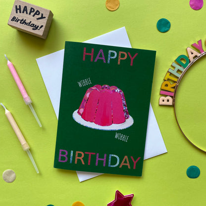 Image shows a green birthday card with a pink collaged jelly and 'Happy Birthday' in colourful lettering.