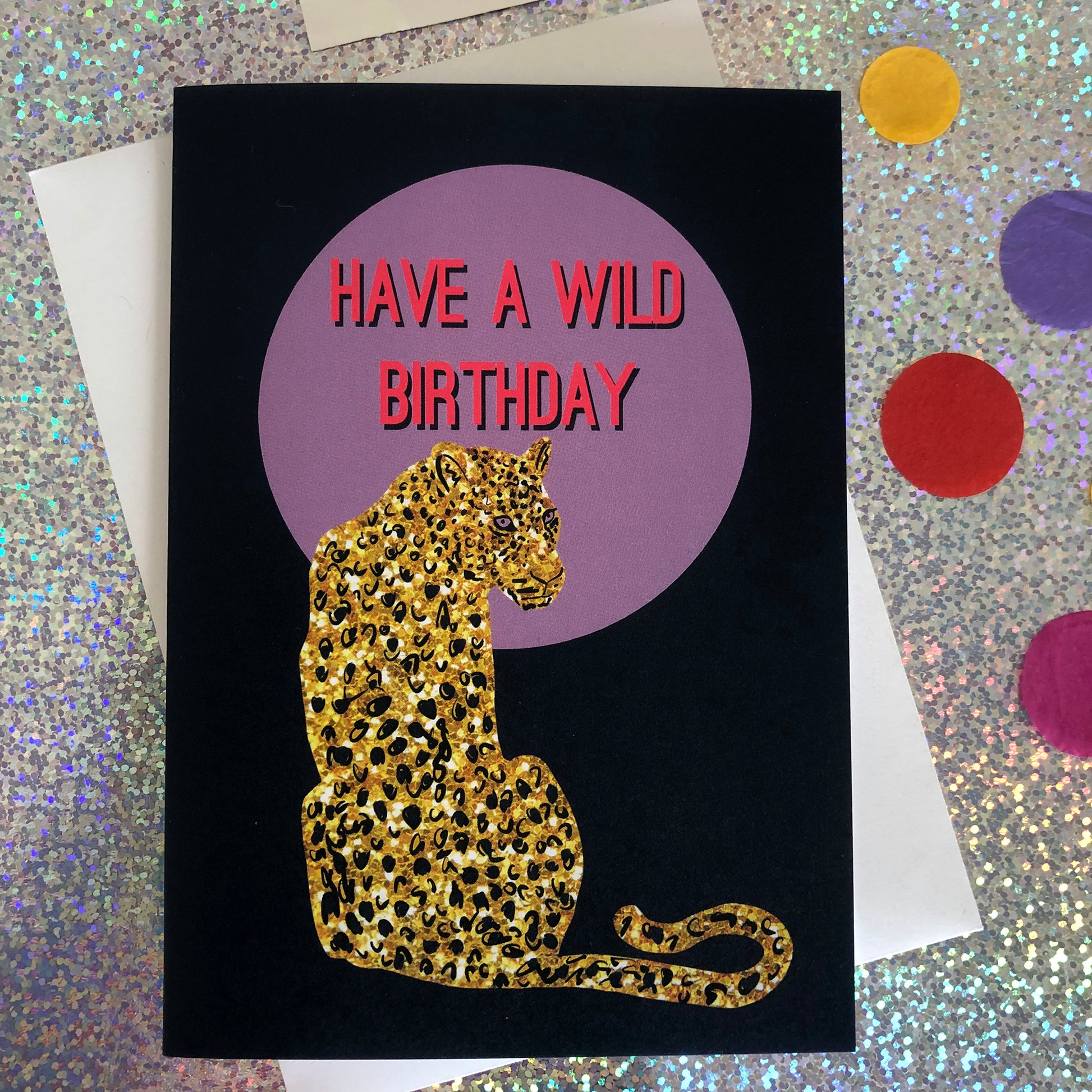 Wild birthday card featuring a gold glitter leopard in front of a lilac full moon.