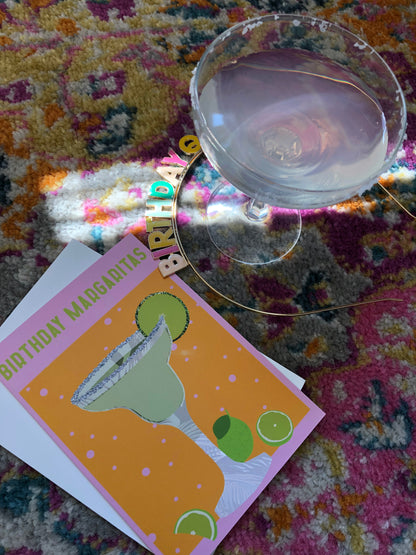 Bright and colourful birthday card featuring a margarita cocktail next to an actual margarita cocktail.
