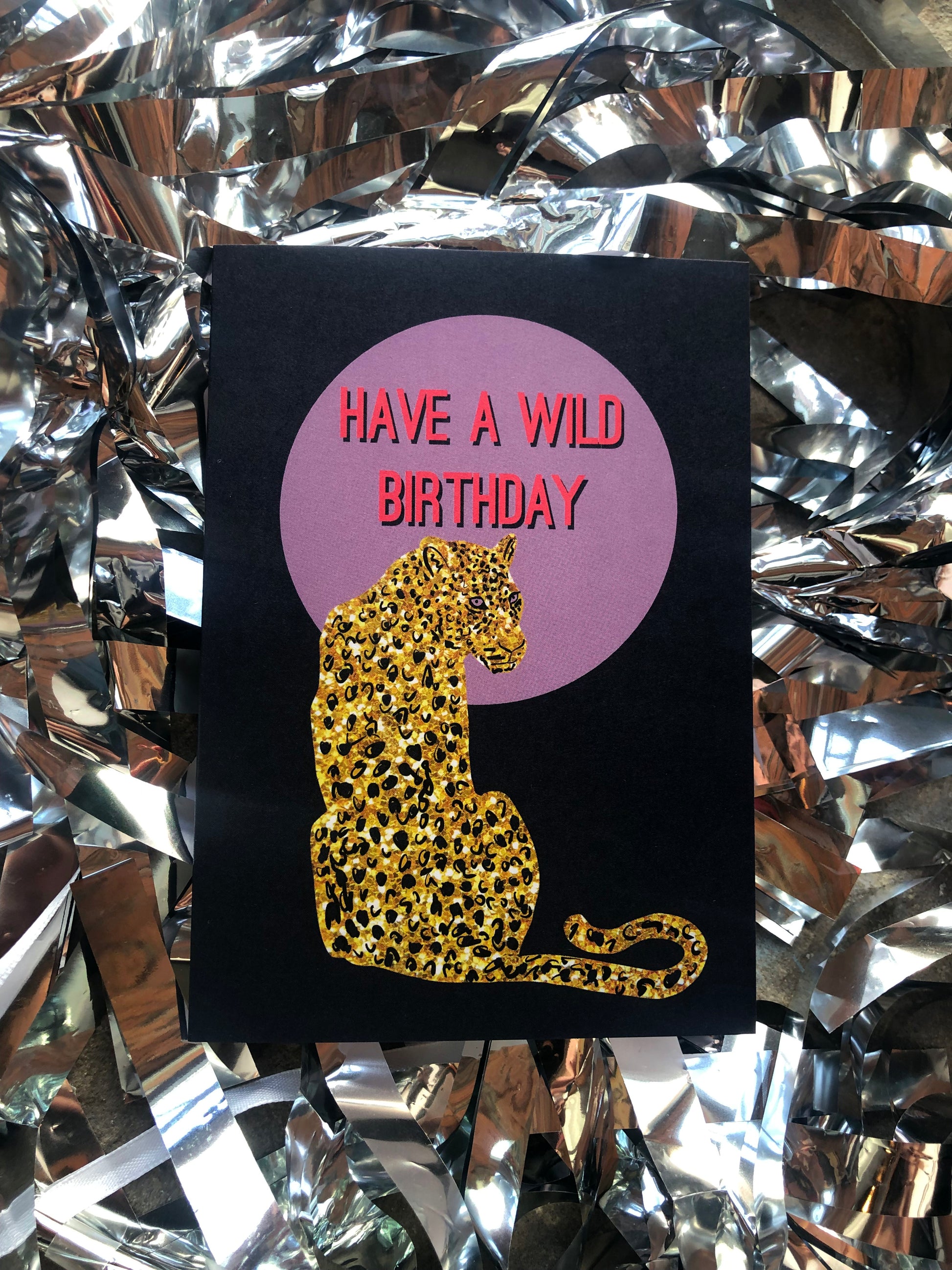 Wild birthday card featuring a gold glitter leopard in front of a lilac full moon.
