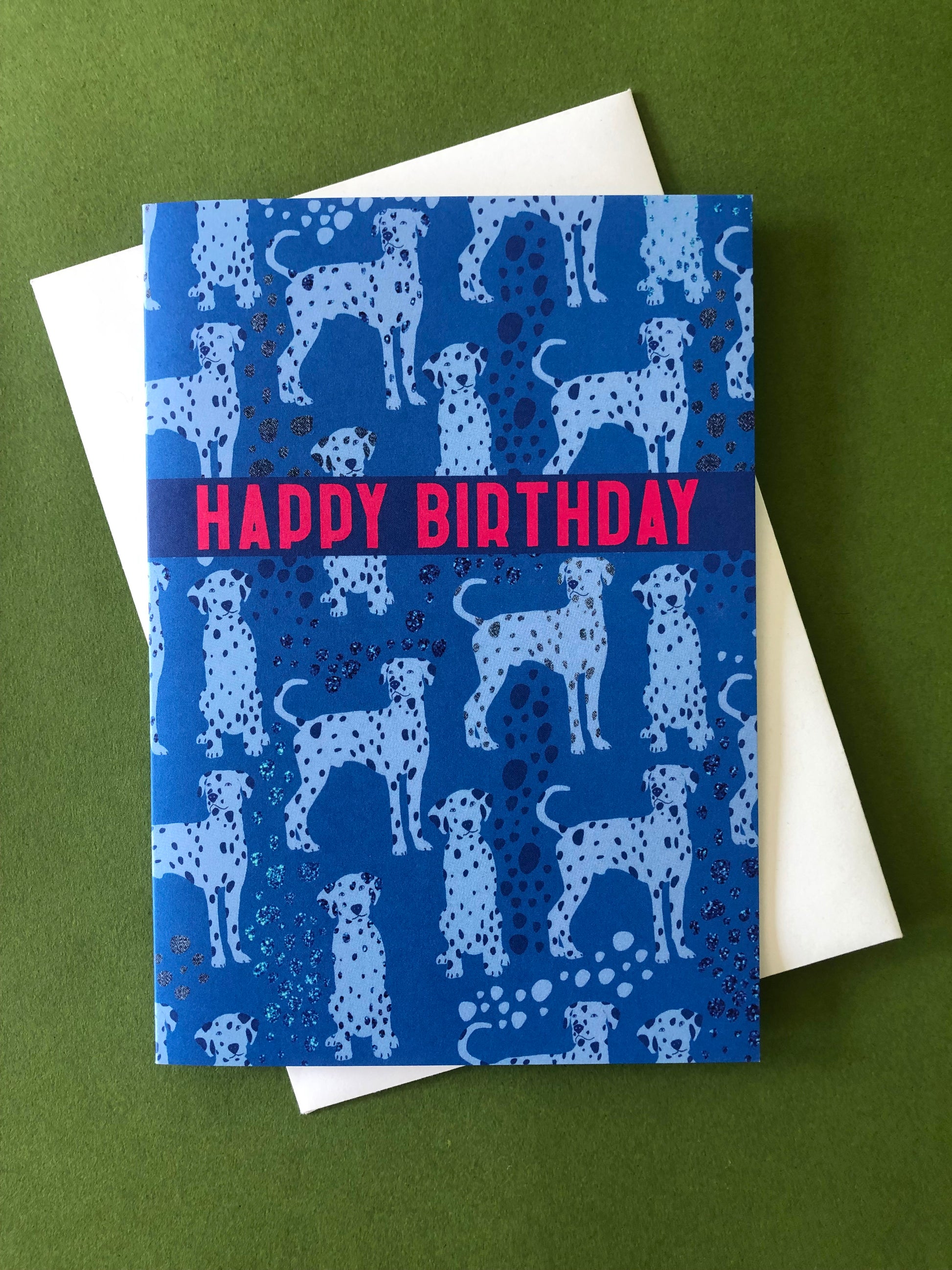 Blue Dalmatian print birthday card featuring a cute dog design on a green background.