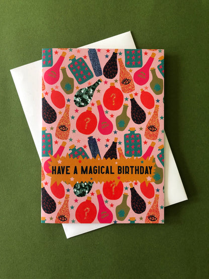 Fun, magical birthday card with colourful magic potion designs on a green background.