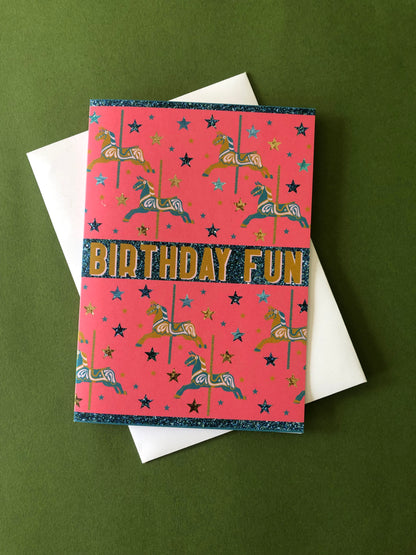Bright and fun birthday card featuring a carousel horse design on a green background