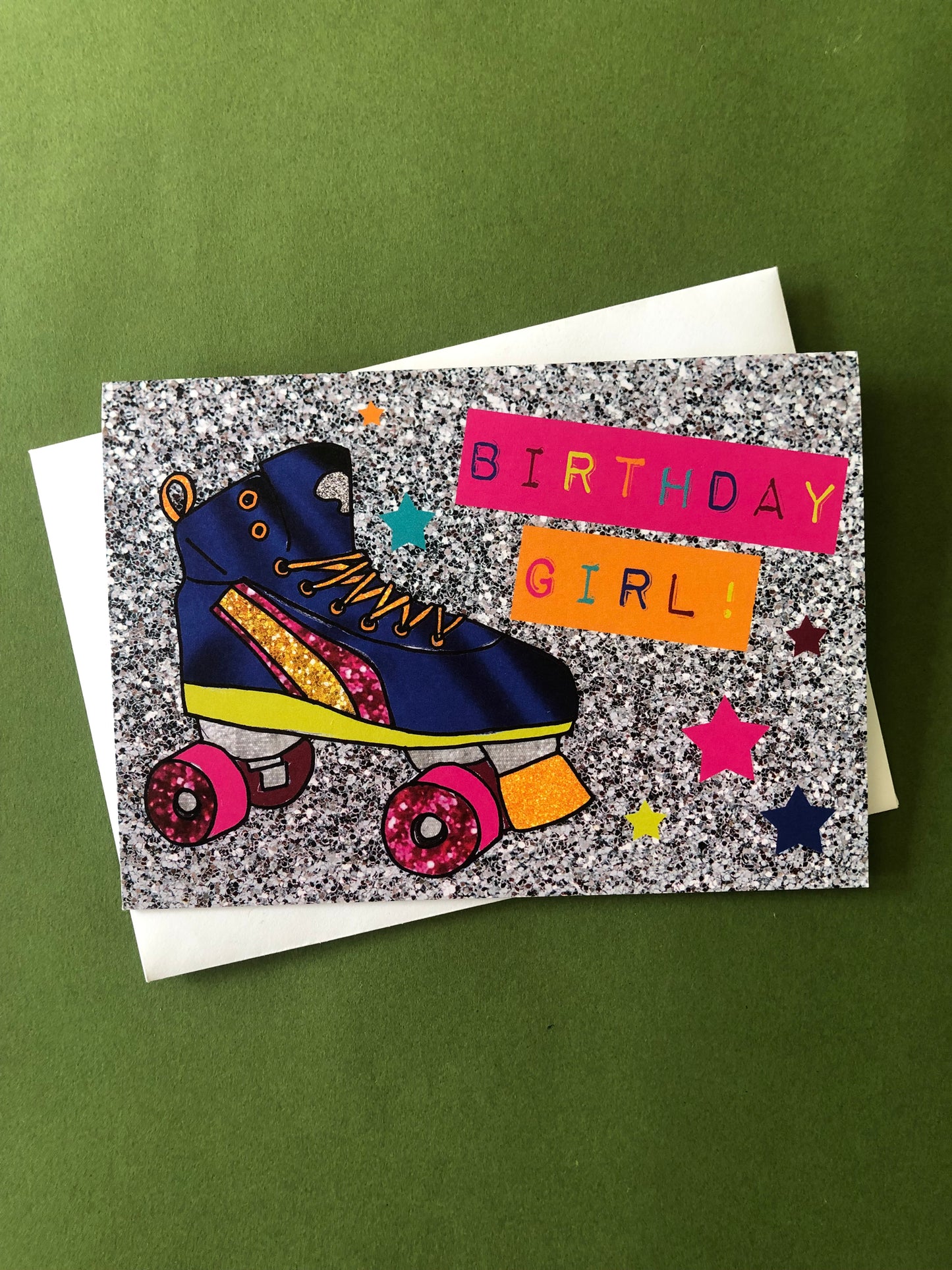Neon and glitter rollerboot birthday girl card on a green background.