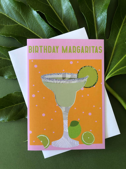 Bright and colourful birthday card featuring a margarita cocktail on a green background with a tropical leaf.