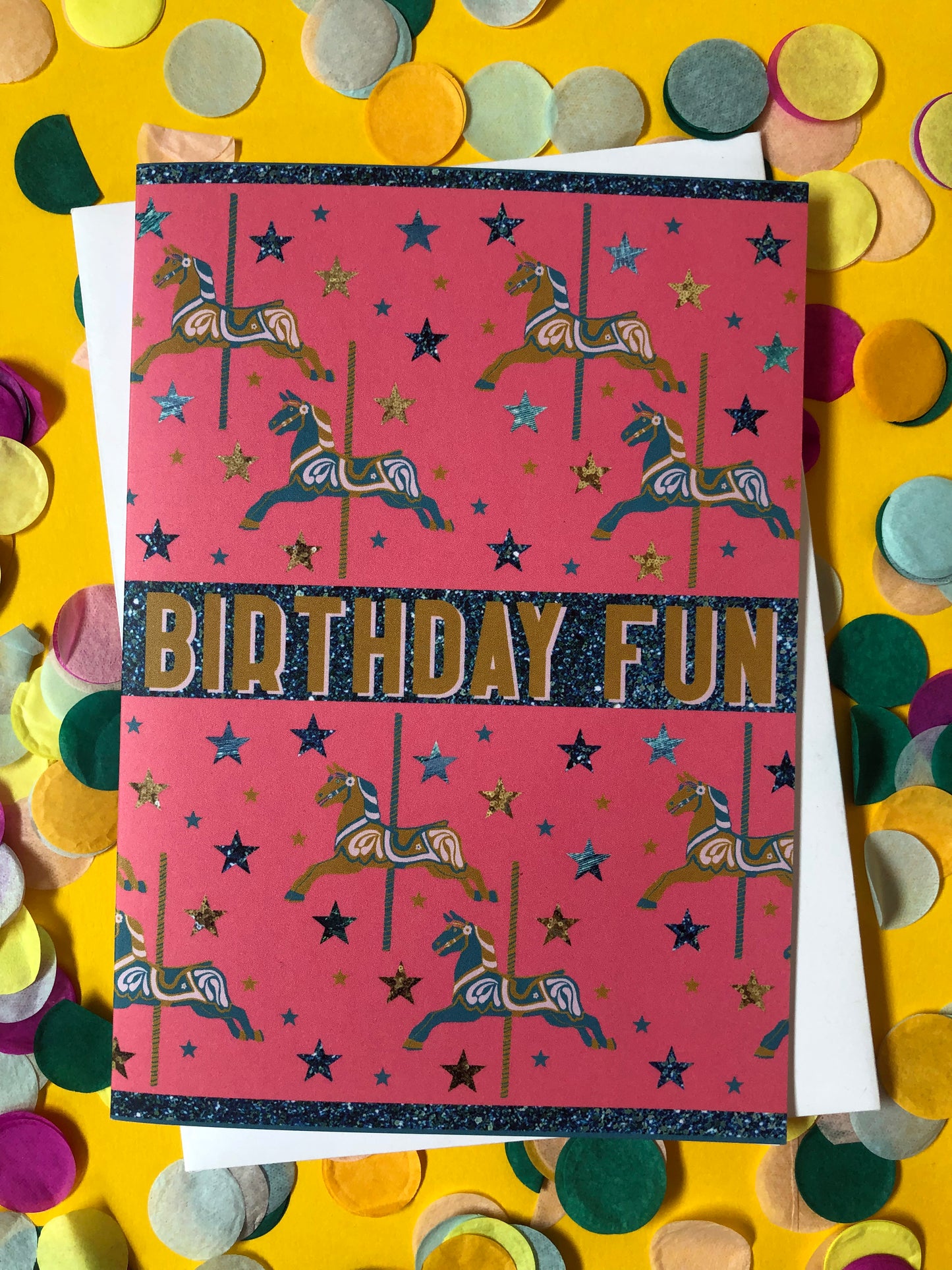 Bright and fun birthday card featuring a carousel horse design on a background of confetti