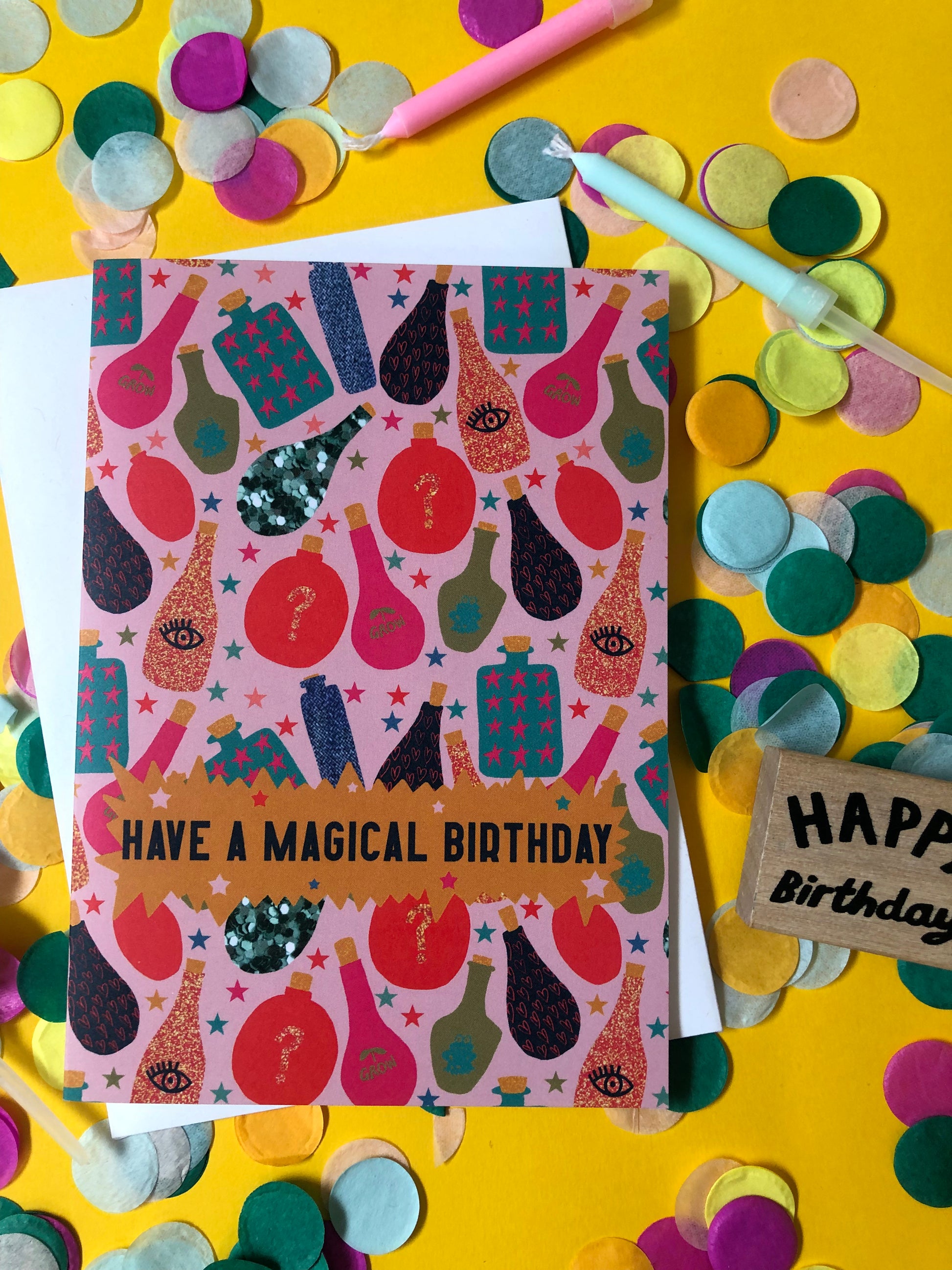 Fun, magical birthday card with colourful magic potion designs on a yellow background.
