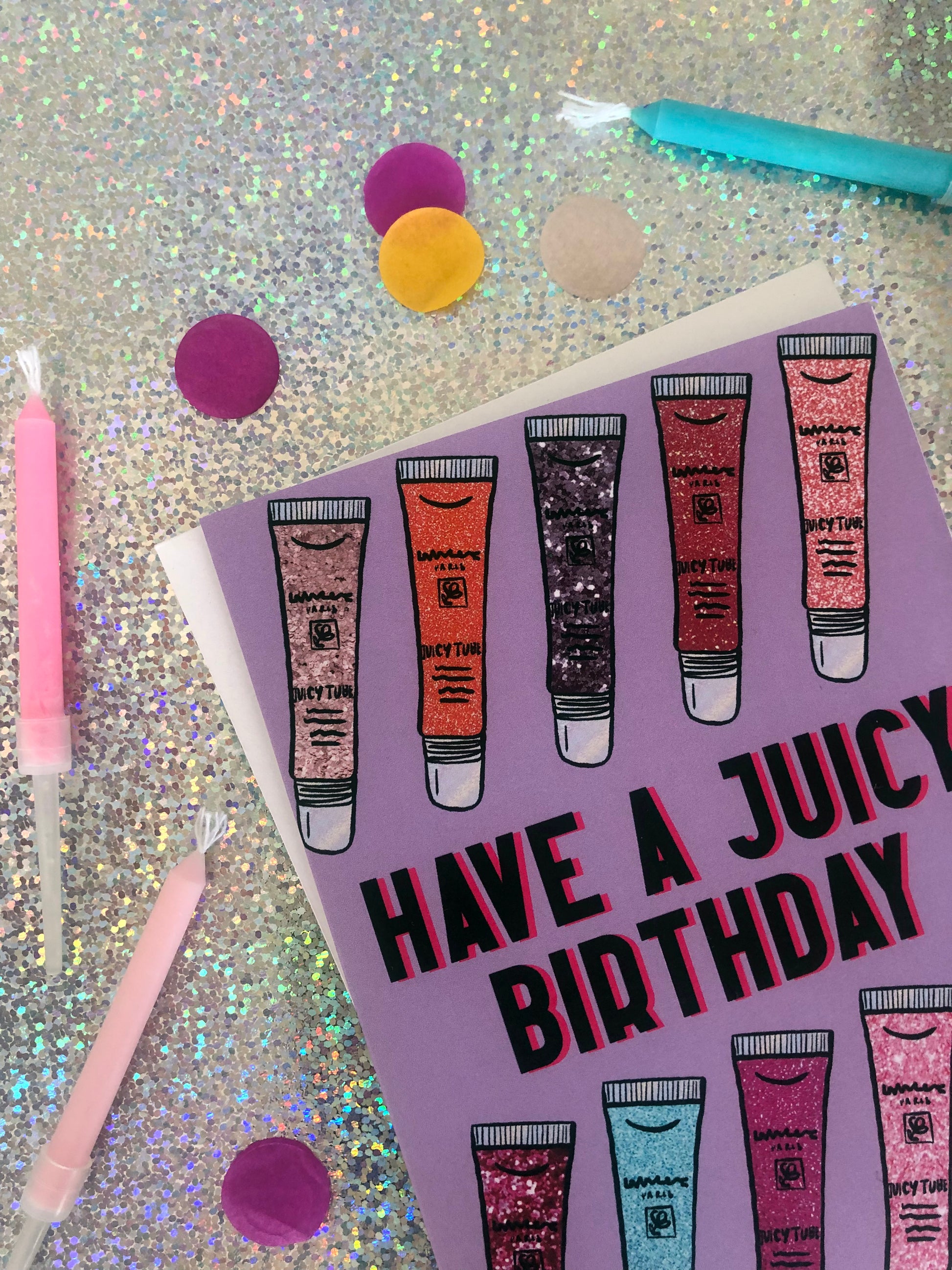Lilac Birthday Card featuring an illustration of noughties cult beauty product juicy tubes lip gloss and the message 'have a juicy birthday'