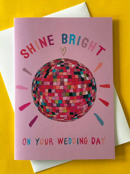 Pink wedding card featuring a glittery rainbow disco ball.