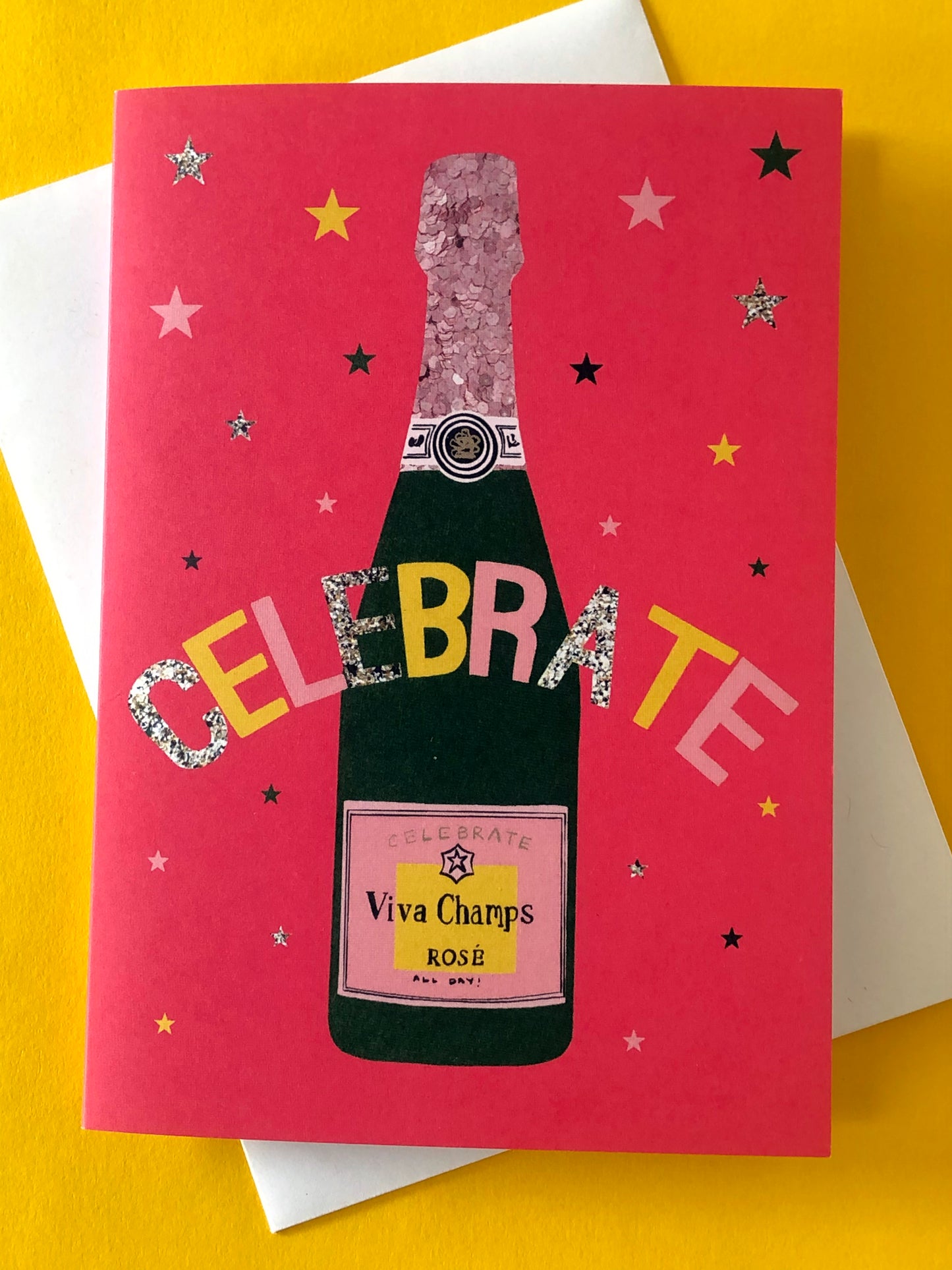 Bright red celebration card featuring a champagne bottle and stars
